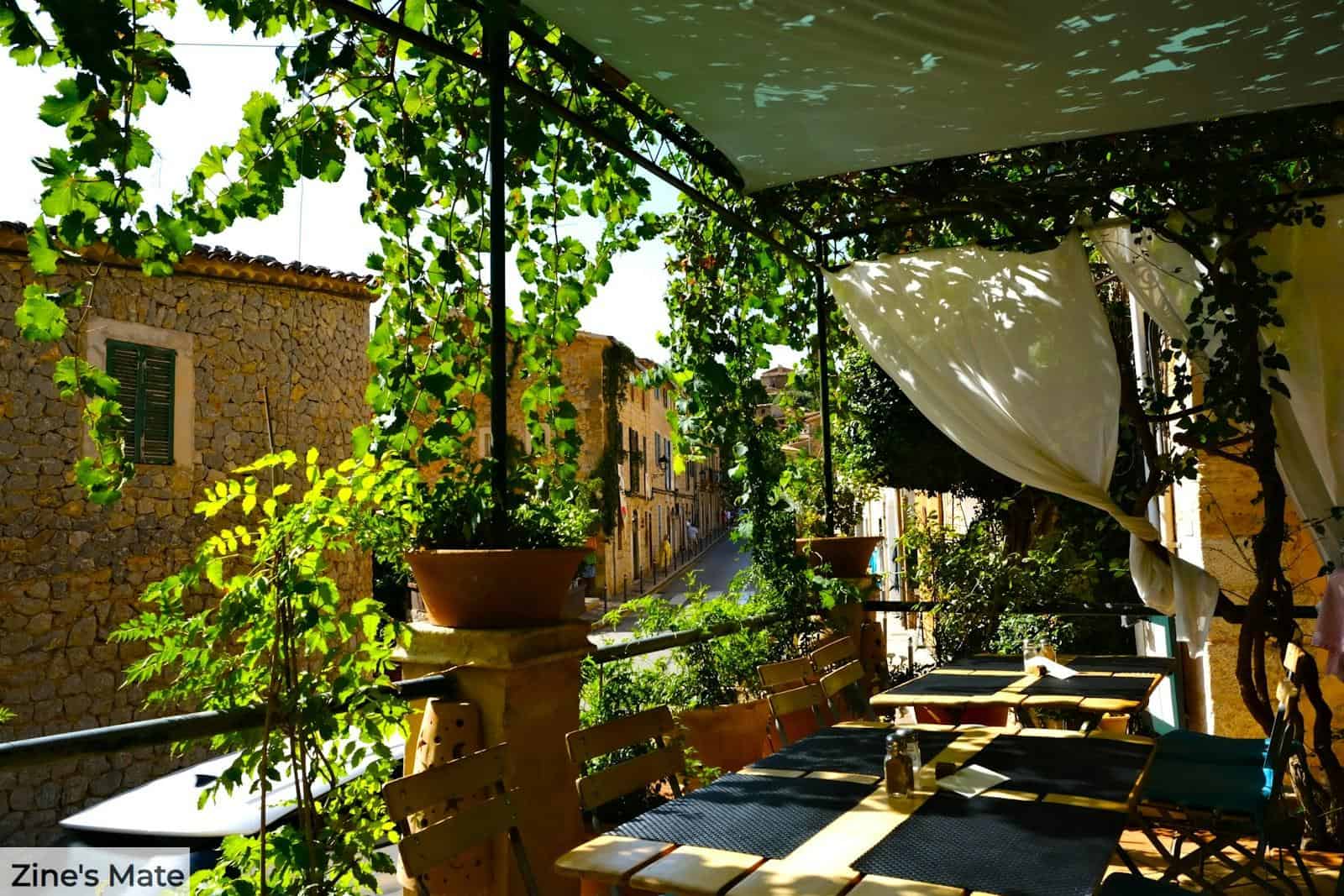 a patio with tables and chairs
