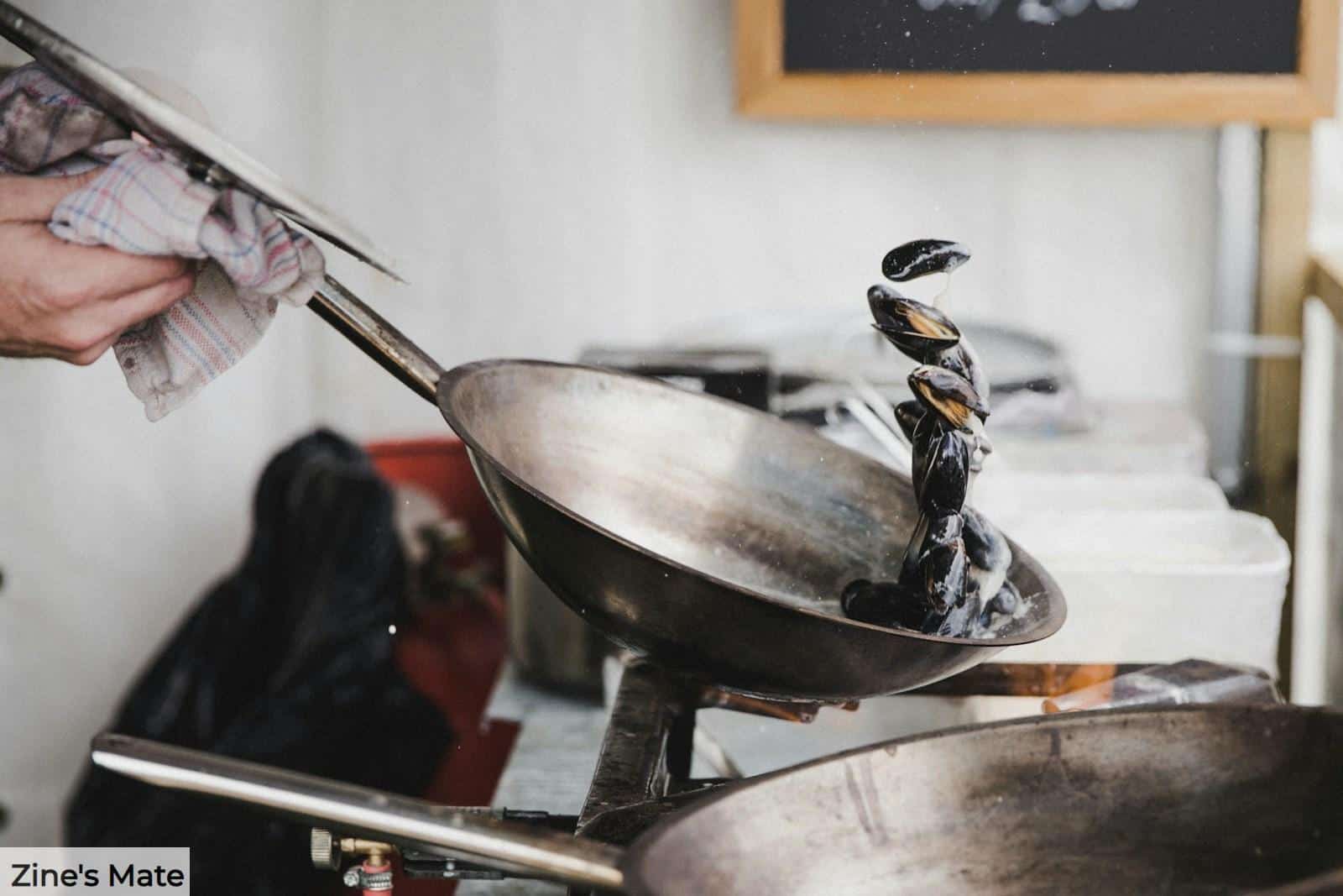 person holding gray cooking pan